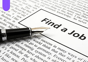 Pen laying on paper with classified ads