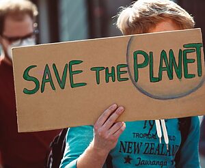 Protester with save the planet sign
